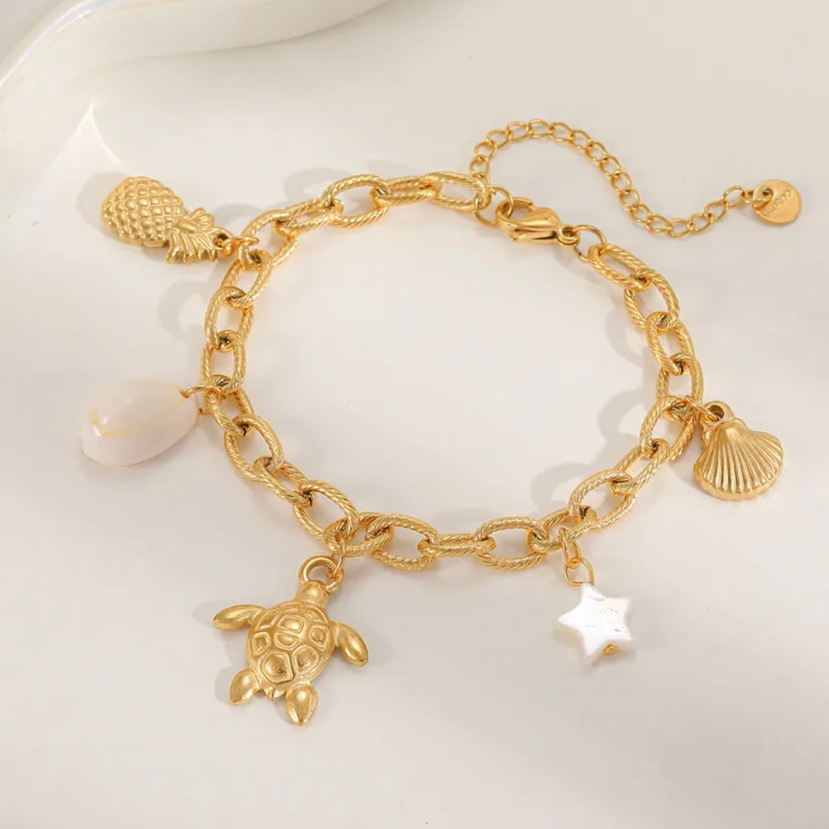 Sea inspired gold plated charm bracelet, charms included.