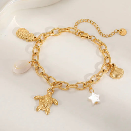 Sea inspired gold plated charm bracelet, charms included.